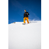 Winter sports - young man running with snowshoes downhill in high mountains covered with lots of snow