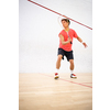 Squash player in action on a squash court (motion blurred image; color toned image)