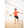 Squash player in action on a squash court (motion blurred image; color toned image)