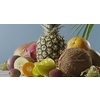 Ripe pineapple with fresh natural exotic fruits on a wooden table on a blue background. Vertical panoramic motion 4K UHD video, 3840, 2160p. Concept of vegetarian diet eating.