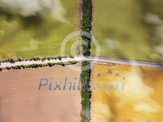 Drone aerial top view above agricultural fields with crossed roads in a sunny day with shadows from clouds. Environmental conservation concept. Natural layout for your ideas. Drone aerial top view above agricultural fields with crossed roads in a sunny day with shadows from clouds. Environmental conservation concept. Natural layout for your ideas.