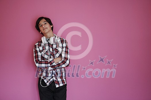 arab teenager with wearing casual school look against pink background wearing headphones arab teenager with wearing casual school look against pink background wearing headphones