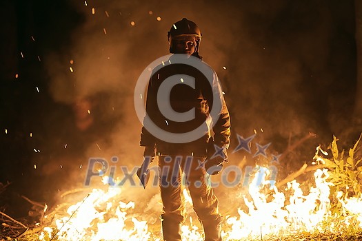 firefighter portrait on authentic fire location in forest