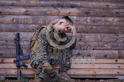 upset  soldier has psychological problems holding his head