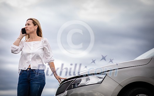 Pretty middle aged woman having car troubles - broken down car on the side of the road, calling the insurance company for assistance Pretty middle aged woman having car troubles - broken down car on the side of the road, calling the insurance company for assistance