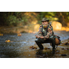 Close-up view of the hands of a fly fisherman holding a lovely trout while  fly fishing on a splendid mountain river