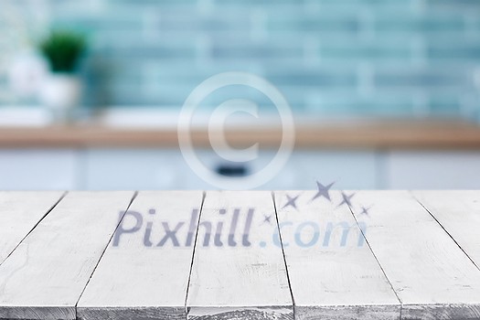 Empty perspective, white wooden boards or table top against blurred kitchen interior on background. May be used as template and mockup for display or montage of your products. Close up, copy space Empty perspective, white wooden boards or table top against blurred kitchen interior on background. May be used as template and mockup for display or montage of your products. Close up, copy space