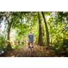 Senior man going fast on his bike during his regular afternoon ride - enjoying actively his retirement - motion blur used to convey speed and movement