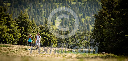 Pretty, young woman hiking outdoors in splendid alpine setting