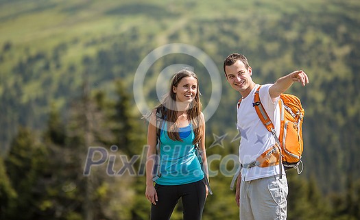 Pretty, young woman hiking outdoors in splendid alpine setting