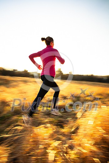 Young woman running outdoors on a lovely sunny winter/fall day (motion blurred image) Young woman running outdoors on a lovely sunny winter/fall day (motion blurred image)