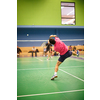 Male badminton player in the middle of a fast paced badminton rally