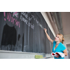 Pretty young teacher writing on the chalkboard/blackboard during class (shallow DOF; color toned image)