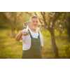 Portrait of a handsome senior man gardening in his garden, on a lovely spring day (color toned image)