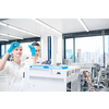 Two young researchers  carrying out scientific research in a lab using a gas chromatograph (shallow DOF; color toned image)