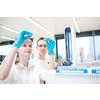 Two young researchers  carrying out scientific research in a lab using a gas chromatograph (shallow DOF; color toned image)