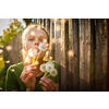 Portrait of happy young woman relaxing on a lovely summer day,  playing with dandelions