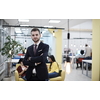 businessman portrait in modern startup business coworking space with bulb decoration representing concept of innovation and idea