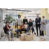 Business team portrait at modern startup office, standing together and posing for photo motivated and creative successful diverse employees group