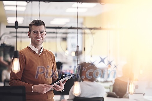 businessman portrait in modern startup business coworking space with bulb decoration representing concept of innovation and idea