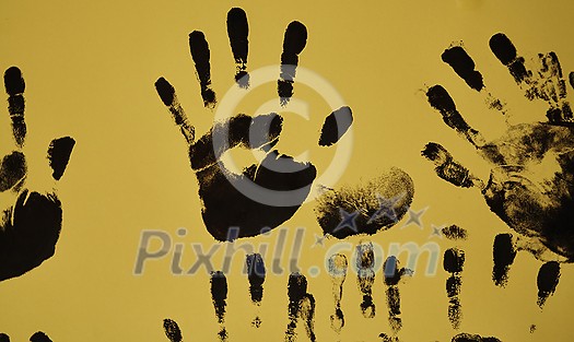 creative children black handprints painting on yellow paper creative children black handprints painting on yellow paper