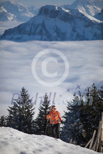 Young woman snowshoeing in high mountains, enjoying a lovely day Young woman snowshoeing in high mountains, enjoying a lovely day