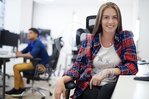 casual business woman working on desktop computer in modern open plan startup office interior