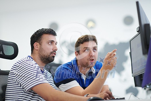 startup business, two male software developers working on computer at new modern open plan office