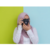 Portrait of Muslim woman photographer with slr camera.
