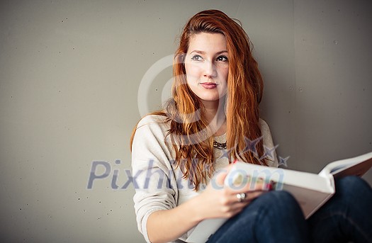 Pretty young college student writing on the chalkboard/blackboard during a math class Pretty young college student writing on the chalkboard/blackboard during a math class