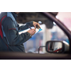 Inside a garage - mechanic carrying out repairs (shallow DOF; color toned image)