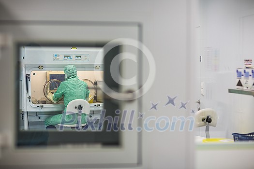 Virus antidote being prepared in a biochem lab with extremely strict precautionary measures (shallow DOF; color toned image) Virus antidote being prepared in a biochem lab with extremely strict precautionary measures (shallow DOF; color toned image)