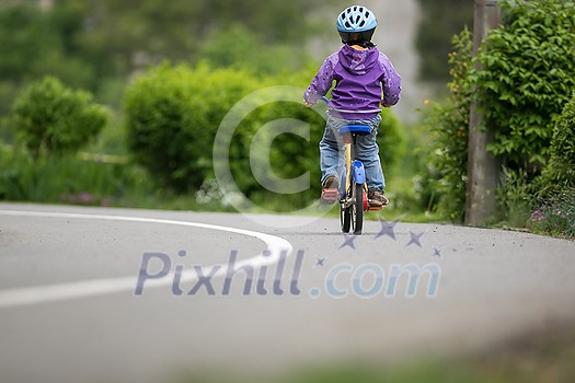 Little cyclist on a little bike (shallow DOF) Little cyclist on a little bike (shallow DOF)
