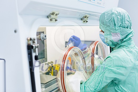 Virus antidote being prepared in a biochem lab with extremely strict precautionary measures (shallow DOF; color toned image) Virus antidote being prepared in a biochem lab with extremely strict precautionary measures (shallow DOF; color toned image)