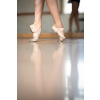 Legs and slippers of classical ballet dancers rehearsing