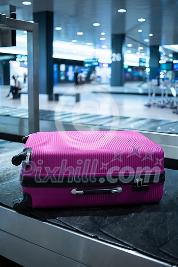 Young woman with her luggage at an international airport, before going through the check-in and the security check before her flight Young woman with her luggage at an international airport, before going through the check-in and the security check before her flight