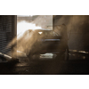 Woman washing her car in a manual carwash (color toned image)