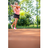 Pretty, young woman tennis player playing on a clay court. Healthy active lifestyle concept