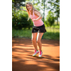 Pretty, young woman tennis player playing on a clay tennis court. Healthy active lifestyle concept