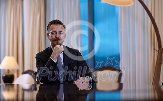 Senior executive businessman at luxury corporate workspace. Portrait of smiling ceo at modern office in stylish suit Senior executive businessman at luxury corporate workspace. Portrait of smiling ceo at modern office in stylish suit