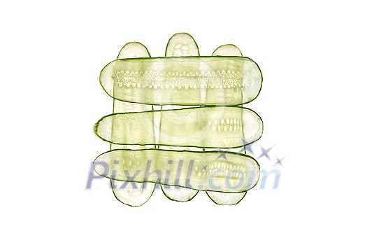 Creative pattern from thin slices of fresh natural organic cucumber vegetable on a white background, copy space. Top view. Creative pattern from thin slices of fresh natural organic cucumber vegetable on a white background, copy space. Top view.
