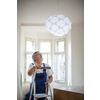 DIY, repair, building and home concept - Senior landlord hanging a new light in a rental appartement (shallow DOF; color toned image)