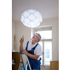 DIY, repair, building and home concept - Senior landlord hanging a new light in a rental appartement (shallow DOF; color toned image)