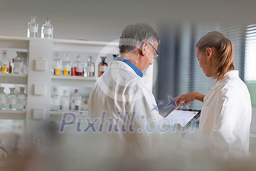 Senior chemistry professor/doctor in a lab (color toned image) teaching students