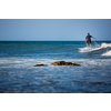Young man surfing the waves on a sunny day