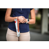 Blind woman walking on city streets, using her white cane to navigate the urban space better and to get to her destination safely