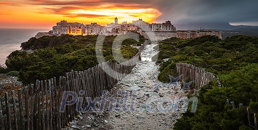 Sunset and storm over the Old Town of Bonifacio, the limestone cliff, South Coast of Corsica Island, France