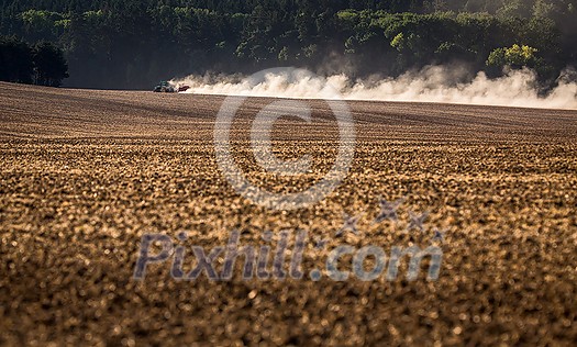 Tractor plowing a dry farm field Tractor plowing a dry farm field