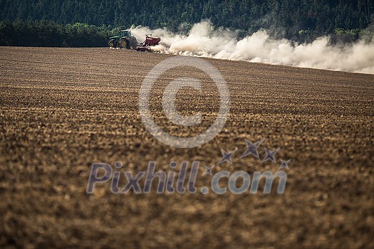 Tractor plowing a dry farm field