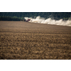 Tractor plowing a dry farm field